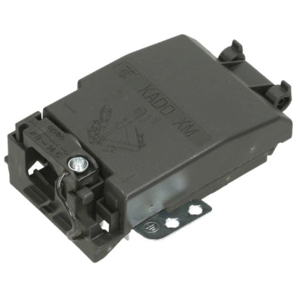 A dark gray automotive electronic module with molded plastic housing, featuring embossed text reading 'KADO XM' and a metal mounting bracket, shown on a plain white background.