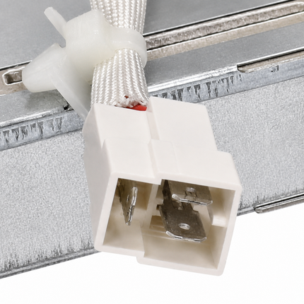 Close-up of a white plastic electrical connector with metal terminals, attached to a braided white cable secured with a white zip tie, against a metallic silver background.