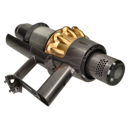 A Dyson cordless vacuum cleaner attachment head, featuring a dark gray and black plastic body with a prominent metallic gold cyclone component, shown on a solid white background.