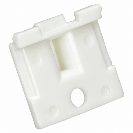 A white plastic door stopper or latch block with a rectangular shape, featuring a central recessed channel, circular mounting holes, and a small tab on top, shown on a plain white background.