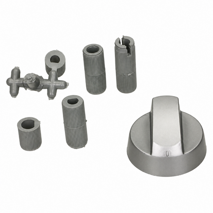 A set of metallic gray replacement parts, including a large round dial with a central tab, three ribbed cylindrical sleeves, a cross-shaped piece, and a broken-looking cylindrical sleeve, displayed on a solid white background.